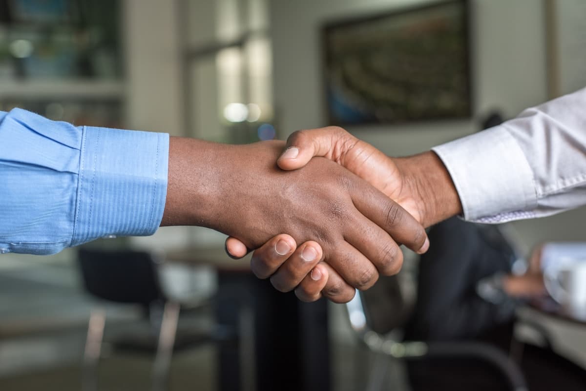 Two people shaking hands after an interview