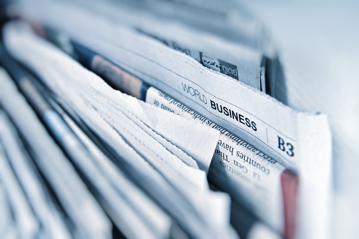 A stack of folded business newspapers